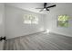 Well lit bedroom with hardwood floors and ceiling fan at 2318 Granada W Cir, St Petersburg, FL 33712