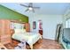 Relaxing bedroom with wood furniture and a ceiling fan at 2440 E Del Webb Blvd, Sun City Center, FL 33573