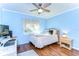 Cozy bedroom with light blue walls and a ceiling fan at 2440 E Del Webb Blvd, Sun City Center, FL 33573