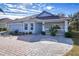 Charming one-story home with a light blue exterior, two-car garage and front porch at 2440 E Del Webb Blvd, Sun City Center, FL 33573