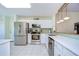 Modern kitchen featuring stainless steel appliances and white cabinets at 2440 E Del Webb Blvd, Sun City Center, FL 33573