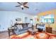 Bright living room with hardwood floors, a ceiling fan and comfortable seating at 2440 E Del Webb Blvd, Sun City Center, FL 33573