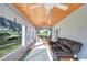 Relaxing screened porch with comfortable seating and wood ceiling at 2440 E Del Webb Blvd, Sun City Center, FL 33573