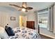 Bedroom with pool view, wood floor and ceiling fan at 2512 Centennial Falcon Dr, Valrico, FL 33596