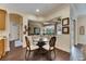 Bright breakfast nook with glass-top table and wicker chairs near kitchen at 2512 Centennial Falcon Dr, Valrico, FL 33596