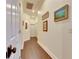 Bright hallway with hardwood floors and framed artwork at 2512 Centennial Falcon Dr, Valrico, FL 33596