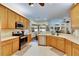 Bright kitchen with wood cabinets, an island, and stainless steel appliances at 2512 Centennial Falcon Dr, Valrico, FL 33596