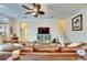 Spacious living room with hardwood floors, a fireplace and a large TV at 2512 Centennial Falcon Dr, Valrico, FL 33596