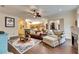 Bright living room featuring a leather couch and a view into the kitchen at 2512 Centennial Falcon Dr, Valrico, FL 33596