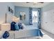 Cozy bedroom with a queen-size bed and blue color theme at 2565 Chapel Oak Bnd, Wesley Chapel, FL 33543