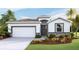 One-story home with a two-car garage and landscaped front yard at 2562 Chapel Oak Bnd, Wesley Chapel, FL 33543