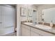 Bathroom with double sinks, granite countertop, and shower/tub combo at 2577 Chapel Oak Bnd, Wesley Chapel, FL 33543