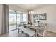 Charming dining room with a farmhouse table and sliding glass doors to the patio at 2577 Chapel Oak Bnd, Wesley Chapel, FL 33543