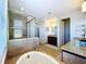 Modern bathroom with a large walk-in shower, soaking tub and double vanity at 2670 Tarragona Way, Wesley Chapel, FL 33543