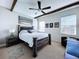 Well-lit bedroom with a dark wood bed frame and ceiling fan at 2670 Tarragona Way, Wesley Chapel, FL 33543