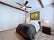 Bright bedroom featuring a comfortable bed, double doors, and ceiling fan at 2670 Tarragona Way, Wesley Chapel, FL 33543