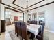 Elegant dining room featuring a beautiful chandelier and leather chairs at 2670 Tarragona Way, Wesley Chapel, FL 33543