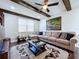 Bright Gathering room with wood beams, comfy seating, and a large format artwork at 2670 Tarragona Way, Wesley Chapel, FL 33543