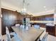 Kitchen features a large wooden dining table and dark wood cabinetry at 2670 Tarragona Way, Wesley Chapel, FL 33543