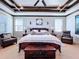 Bright main bedroom with wood beam ceiling and plush seating at 2670 Tarragona Way, Wesley Chapel, FL 33543