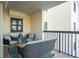 Balcony with seating area and partial ocean view at 3200 Gulf Blvd # 204, St Pete Beach, FL 33706