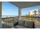 Relaxing balcony with ocean view and seating at 3200 Gulf Blvd # 204, St Pete Beach, FL 33706