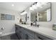 Double vanity bathroom with gray cabinets and black fixtures at 3200 Gulf Blvd # 204, St Pete Beach, FL 33706