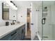 Bathroom with gray vanity, walk-in shower, and modern fixtures at 3200 Gulf Blvd # 204, St Pete Beach, FL 33706