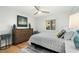 Bright bedroom with a queen bed, dresser, and ceiling fan at 3200 Gulf Blvd # 204, St Pete Beach, FL 33706