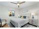 Bedroom with a queen bed, nightstands, and ceiling fan at 3200 Gulf Blvd # 204, St Pete Beach, FL 33706