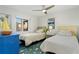 Two twin beds in a well-lit bedroom with ocean views at 3200 Gulf Blvd # 204, St Pete Beach, FL 33706