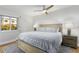 Spacious bedroom with a king-size bed, nightstands, and ceiling fan at 3200 Gulf Blvd # 204, St Pete Beach, FL 33706