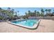 Relaxing community pool with patio and lounge chairs at 3200 Gulf Blvd # 204, St Pete Beach, FL 33706