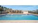 Refreshing community pool with plenty of lounge chairs at 3200 Gulf Blvd # 204, St Pete Beach, FL 33706