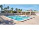 Sparkling community pool with surrounding patio area at 3200 Gulf Blvd # 204, St Pete Beach, FL 33706