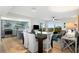 Open concept dining area with a large wooden table and seating for six at 3200 Gulf Blvd # 204, St Pete Beach, FL 33706