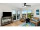 Living Room with ocean view, comfy armchairs, and hardwood floors at 3200 Gulf Blvd # 204, St Pete Beach, FL 33706