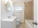 Clean bathroom with white vanity and beige tile tub surround at 3709 W Oklahoma Ave, Tampa, FL 33611