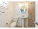 Updated bathroom with pedestal sink and beige tile shower at 3709 W Oklahoma Ave, Tampa, FL 33611