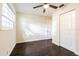 Bright bedroom with dark wood floors and double door closet at 3709 W Oklahoma Ave, Tampa, FL 33611