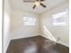 Bright bedroom with two windows and dark wood floors at 3709 W Oklahoma Ave, Tampa, FL 33611