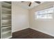 Bedroom with built-in shelving and dark wood floors at 3709 W Oklahoma Ave, Tampa, FL 33611