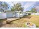 Light blue house with a wooden deck, fire pit, and fenced backyard at 3709 W Oklahoma Ave, Tampa, FL 33611