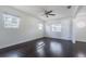 Bright living room featuring dark hardwood floors and two windows at 3709 W Oklahoma Ave, Tampa, FL 33611