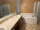 Bathroom with double vanity and a jetted tub at 3830 Stornoway Dr, Land O Lakes, FL 34638