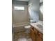 Bathroom with tub, toilet and wood vanity at 3830 Stornoway Dr, Land O Lakes, FL 34638