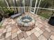 Brick patio with fire pit and lounge chair at 3830 Stornoway Dr, Land O Lakes, FL 34638