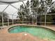 Relaxing kidney-shaped pool with screened enclosure at 3830 Stornoway Dr, Land O Lakes, FL 34638