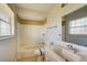 Clean bathroom featuring a tub shower, single sink vanity, and neutral tile at 4173 Driver Ln, Port Charlotte, FL 33981