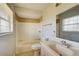 Clean bathroom featuring a tub shower, single sink vanity, and neutral tile at 4173 Driver Ln, Port Charlotte, FL 33981